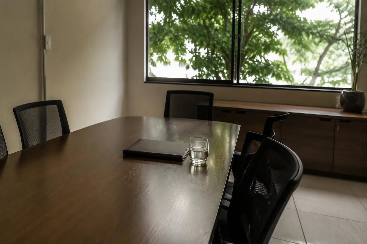 Cadeiras em volta da mesa de reunião, ainda vazias antes do encontro